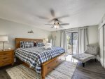 Master Bedroom with King Bed and Patio Access at 606 Queens Grant